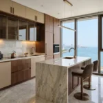 La Mer Mumbai Central 3 BHK Kitchen With Marble Island Wooden Cabinets Glossy Flooring And Arabian Sea View