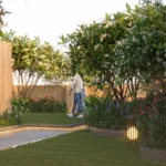 Luminaara 10th Road Khar West Landscaped Garden With Walking Path Flowering Plants Decorative Outdoor Lights Green Lawn And Tree Lined Open Space