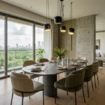 2 BHK Mehta Marquina Goregaon East elegant dining space with oval dining table pendant lights and panoramic skyline views