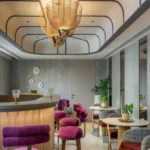 Piramal Revanta Mulund West Gold Mesh Pendant Magenta Velvet Bar Stool Curved Counter Residents Cafe Lounge