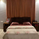 R Paradise Tungarli Lonavala 6 BHK Villa Bedroom With Curtains And Wooden Bed