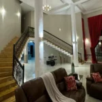 R Paradise Tungarli Lonavala 6 BHK Villa Living Room With Grand Staircase And Columns