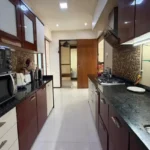Resale 4 BHK Oberoi Springs Andheri West Modern Kitchen With Parallel Counter Layout Storage Cabinets And Premium Finishes