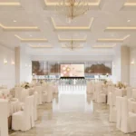 Vikas 11 Mulund West White Coffered Ceiling Gold Chandelier White Round Table Chair Row LED Screen Banquet Hall