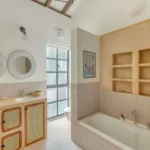 Villa Casa Brilhante Parra Goa 4 BHK Bathroom With Bathtub Double Vanity Mirror Natural Lighting And Elegant Neutral Interior Finish