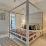 Villa Casa Brilhante Parra Goa 4 BHK Bedroom With Wooden Canopy Bed White Interior Warm Bedside Lighting Large Windows
