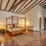 Villa Casa Brilhante Parra Goa 4 BHK Master Bedroom With Wooden Flooring High Sloped Ceiling Canopy Bed Warm Lighting
