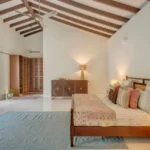 Villa Casa Brilhante Parra Goa 4 BHK Spacious Bedroom With High Ceiling Wooden Furniture Open Wardrobe Area Soft Lighting
