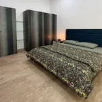 3 BHK One Avighna Park Bedroom with Blue Headboard and Wardrobes