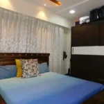 5 BHK Lake Superior Powai Bedroom with Blue Bed and Wardrobe