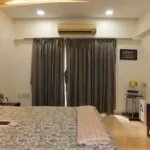 5 BHK Lake Superior Powai Bedroom with Grey Curtains and TV
