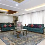 5 BHK Lake Superior Powai Living Room with Blue Sofa and Curtains