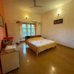3 BHK Beach Villa Nagaon Bedroom with Yellow Bedspread