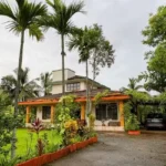 3 BHK Beach Villa Nagaon Front Elevation with Lawn and Palms