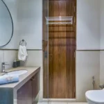 4 BHK Villa Saral Alibaug Bathroom Vanity with Wooden Door