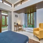 4 BHK Villa Saral Alibaug Blue Bedroom Corner with Yellow Armchair