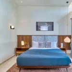 4 BHK Villa Saral Alibaug Blue Bedroom with Balcony Access
