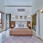 4 BHK Villa Saral Alibaug Brown Bedroom with Wraparound Windows