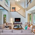 4 BHK Villa Saral Alibaug Double-Height Living Area with TV and Pool View