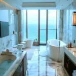 Oceanic Carter Road Bandra Deluxe Bedroom Showcasing Marble Bathroom Sea View