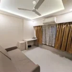 3 BHK Maker Tower Cuffe Parade Bedroom With Sofa And Mirrored Wardrobe