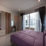 Daivi Eterneety Borivali Bedroom With Purple Bed And Balcony
