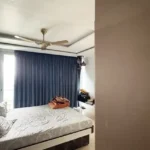 3 BHK Oberoi Exquisite Goregaon Bedroom with Blue Curtains