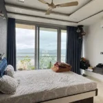 3 BHK Oberoi Exquisite Goregaon Bedroom with Blue Headboard and Balcony View