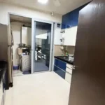 3 BHK Oberoi Exquisite Goregaon Kitchen with Blue and White Cabinets