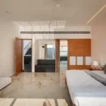 3 BHK Villa Infiniti Bay Dabolim Bogmalo Beach Goa Bedroom with Grey Throw and TV