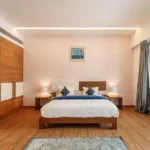 3 BHK Villa Infiniti Bay Dabolim Bogmalo Beach Goa Bedroom with Wooden Wardrobe and Blue Throw
