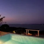 3 BHK Villa Infiniti Bay Dabolim Bogmalo Beach Goa Illuminated Pool with Bay View at Duskq