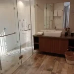 4 BHK Villa Khopoli Bathroom with Wooden Vanity and Glass Shower