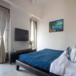 4 BHK Villa Khopoli Bedroom with Blue Bedding and Balcony Access