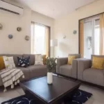 4 BHK Villa Khopoli Living Room with Grey Sofa and Armchairs
