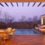 4 BHK Villa Khopoli Pool Deck with Sun Loungers at Dusk