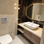 8 BHK Jodi Windsor Grande Andheri West Bathroom With Backlit Oval Mirror And Vanity