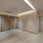 8 BHK Jodi Windsor Grande Andheri West Bedroom With Beige Curtains And Ensuite Door