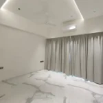 8 BHK Jodi Windsor Grande Andheri West Bedroom With Veined Floor And Grey Curtains