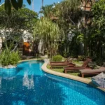 Taj Mount Kusur Villas Resort Curved Swimming Pool with Garden Loungers