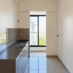 3 BHK Amaris Park Matunga East Compact Culinary Space With Dark Stone Counter Steel Sink