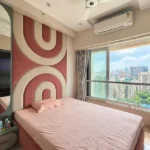3 BHK Kalpataru Radiance Goregaon Charming Rose Toned Room With Curved Feature Backdrop