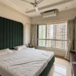 3 BHK Kalpataru Radiance Goregaon Bedroom With Emerald Padded Backdrop Cream Curtains