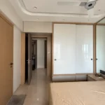 3 BHK Kalpataru Radiance Goregaon Neutral Toned Sleeping Space With Glossy White Closet Doors