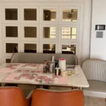 3 BHK Kalpataru Radiance Goregaon Cozy Eating Nook With Stone Top Table Orange Chairs