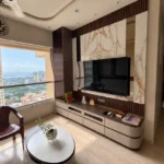 3 BHK Kalpataru Radiance Goregaon Stylish Drawing Room With Veined Stone Feature Panel Media Unit