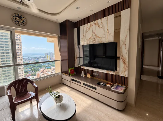 3 BHK Kalpataru Radiance Goregaon Stylish Drawing Room With Veined Stone Feature Panel Media Unit