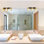 3 BHK Mayberry Villas Anjuna Goa Spacious Washroom With Wide Vanity Mirror Dual Sinks And Gold Bar Lighting