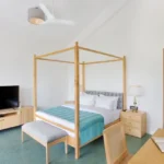 3 BHK Mayberry Villas Anjuna Goa Minimal Suite With Wooden Four Poster Frame Teal Throw