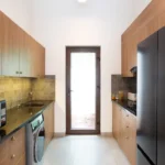 3 BHK Mayberry Villas Anjuna Goa Functional Chef Kitchen With Timber Cabinetry Gold Backsplash